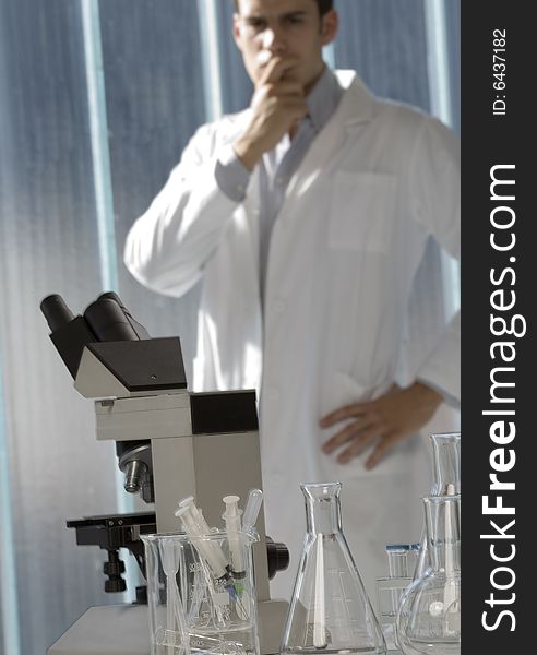 Scientist thinking in his lab, focus on the microscope. Scientist thinking in his lab, focus on the microscope