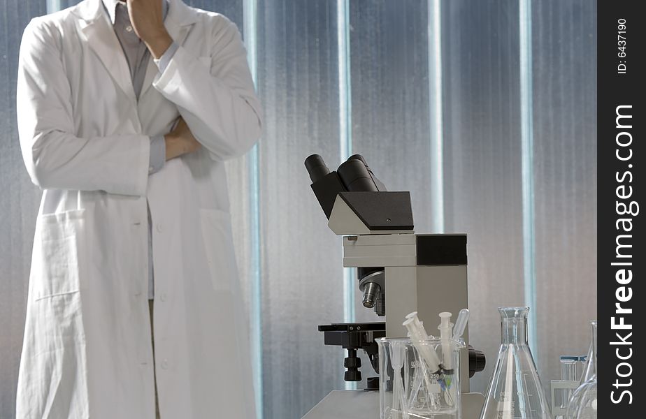 Scientist thinking in his lab, focus on the microscope. Scientist thinking in his lab, focus on the microscope