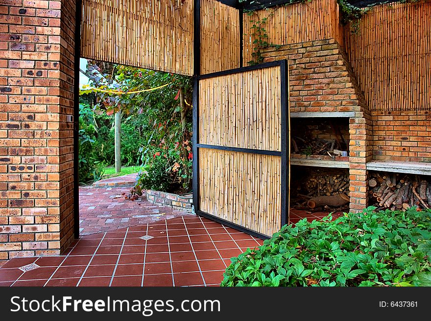 Reed door into garden. Shot in farm near Stellenbosch, Western Cape, South Africa.