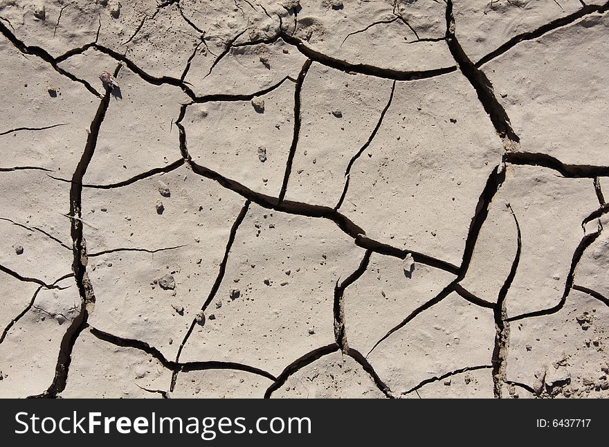 A useful background depicting a                       nature / environment al image of cracked dry mud. A useful background depicting a                       nature / environment al image of cracked dry mud.