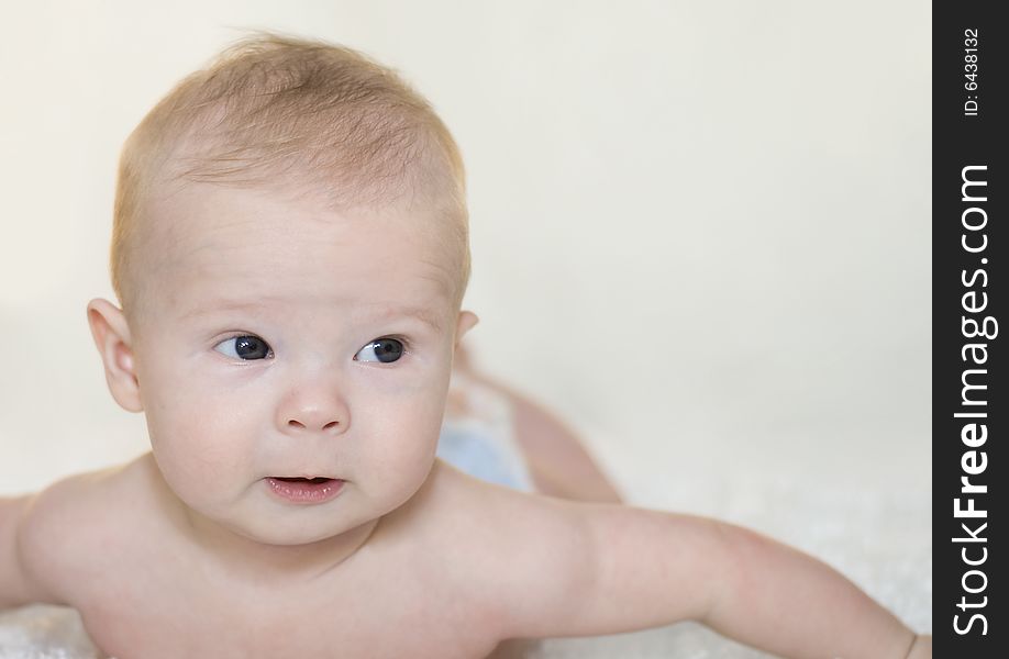 Adorable baby looking with great intent at something off to the side. Adorable baby looking with great intent at something off to the side