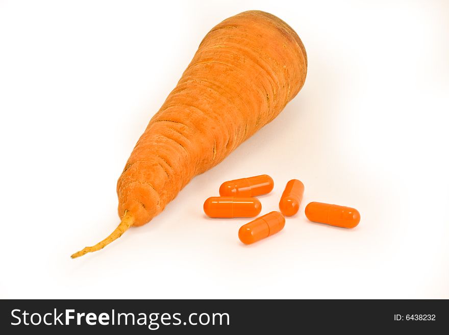 Vitamin pills with carrot on isolated white. Make your choice. Vitamin pills with carrot on isolated white. Make your choice