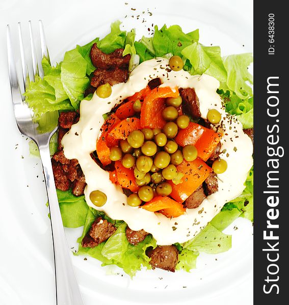 Chicken Salad Composed Chicken Liver and Pepper Dressed with Salad Leaves and Green Peas. Isolated on White Background