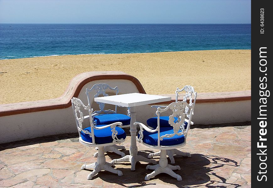 The empty chairs and the table on Lovers' beach in Cabos San Lucas, Mexico. The empty chairs and the table on Lovers' beach in Cabos San Lucas, Mexico.