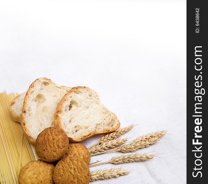 Bread composition with grain on white fabric background