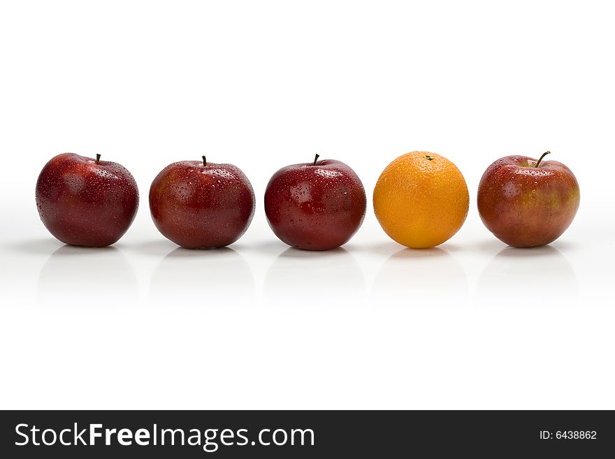 Red apple row with an orange toward the right. Red apple row with an orange toward the right