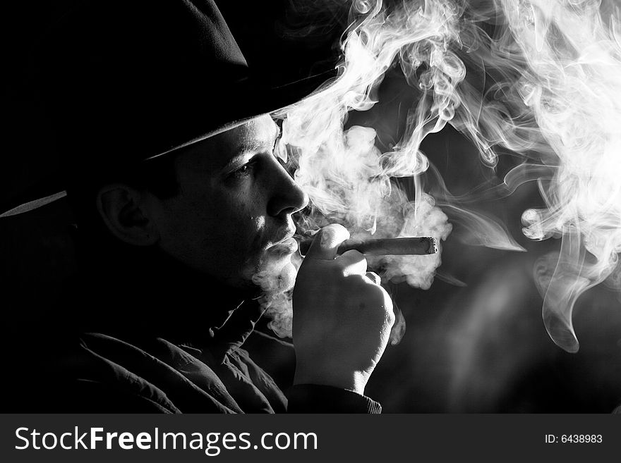 Black and white images of a man in clubs of smoke