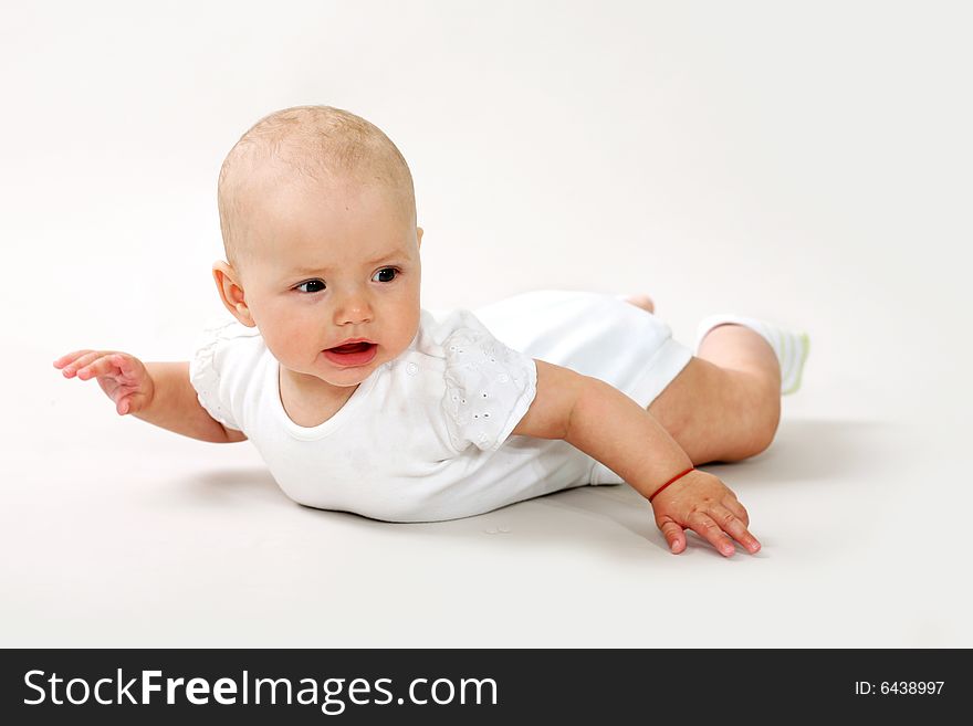 An image of a little baby crawning in studio. An image of a little baby crawning in studio