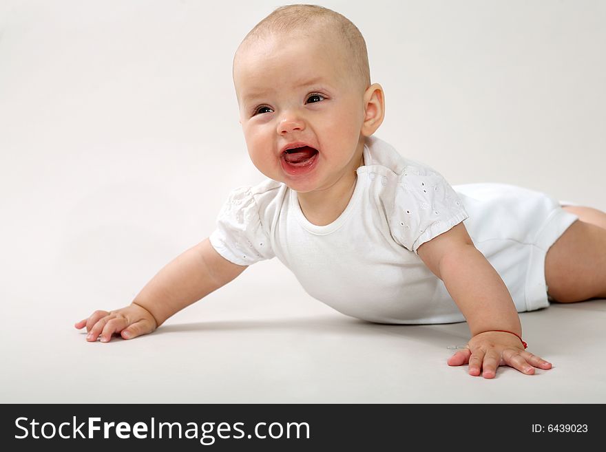 An image of a little baby crawning in studio