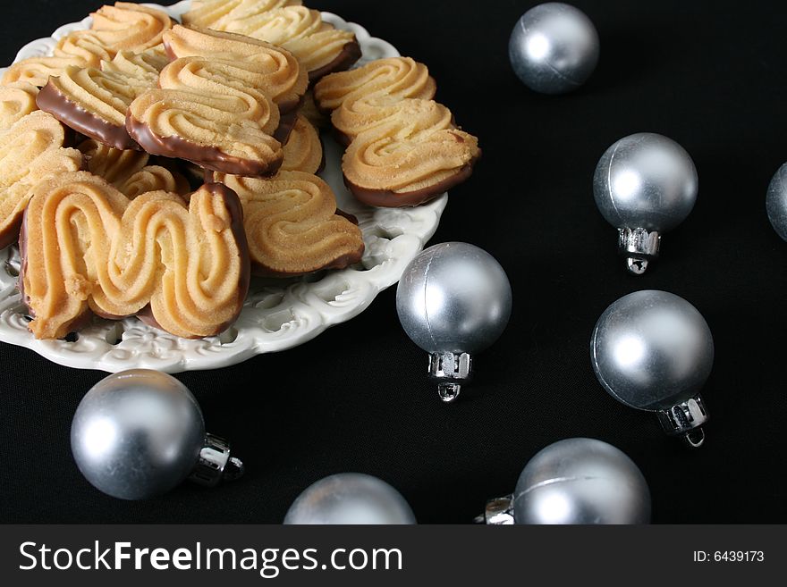 Christmas cookies with silver ball decorations on a black background