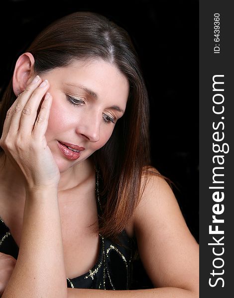 Beautiful brunette female model against a dark background. Beautiful brunette female model against a dark background