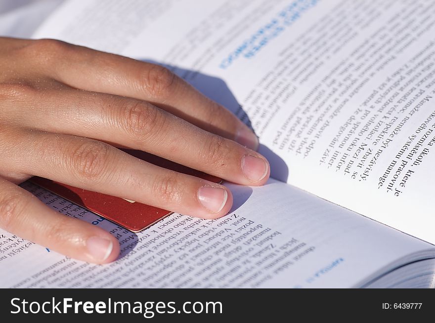 Hand of a girl reading a book