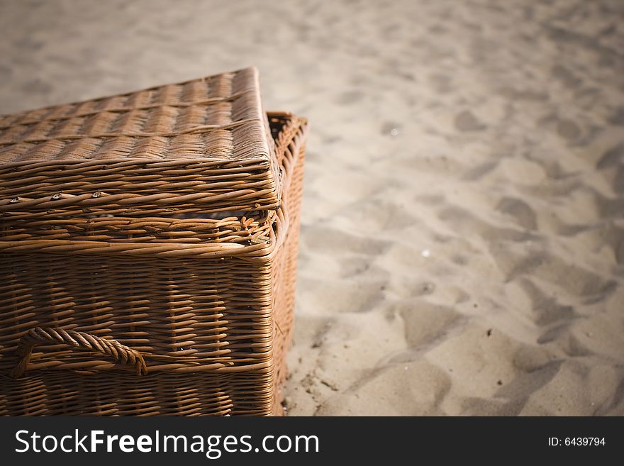 Picnic basket on the beach - focus on basket