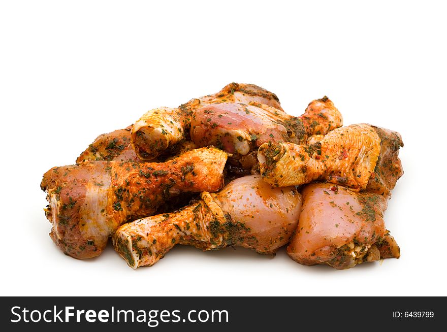 Raw chicken drumsticks on white background