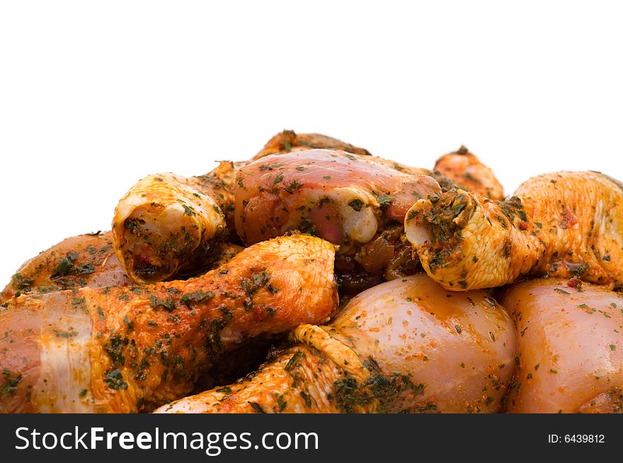 Raw chicken drumsticks on white background