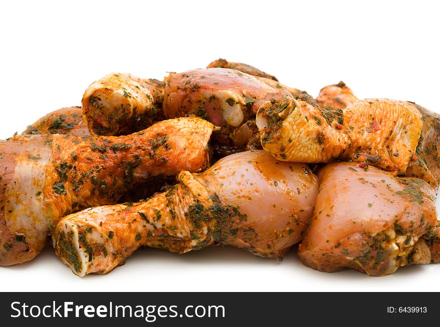 Raw chicken drumsticks on white background