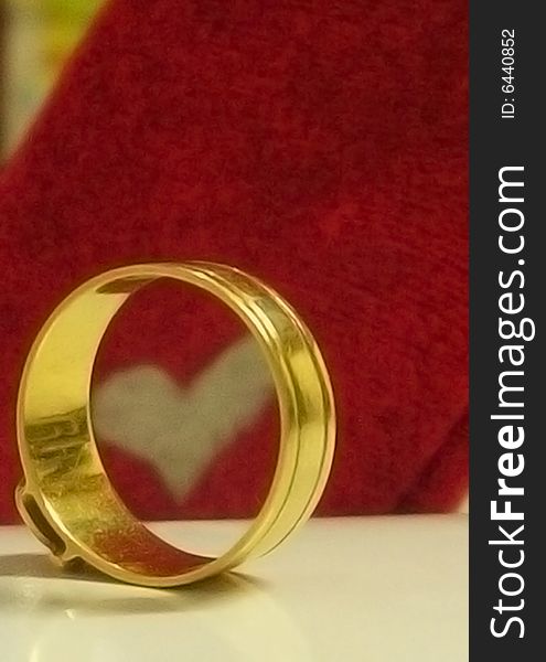 Golden ring and heart is a symbol of love and wedding