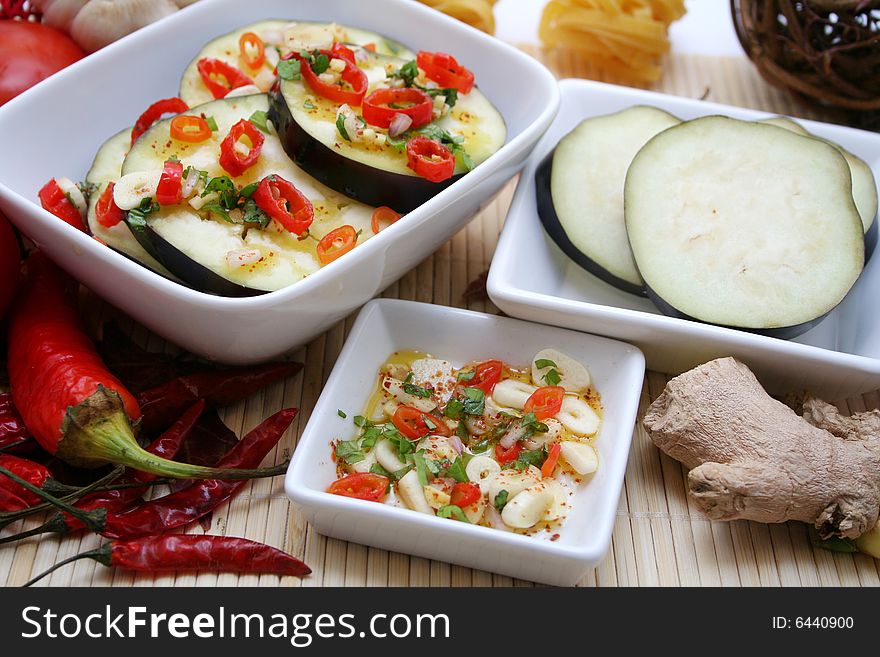 Some fresh aubergines with chili in a bowl