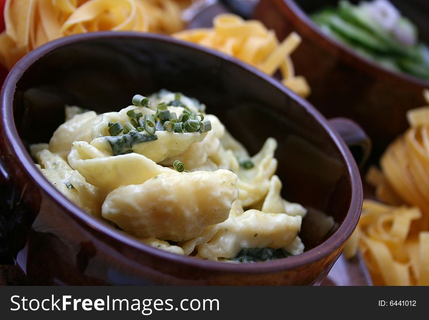 Some italian noodles with fresh spinach and cheese-sauce. Some italian noodles with fresh spinach and cheese-sauce