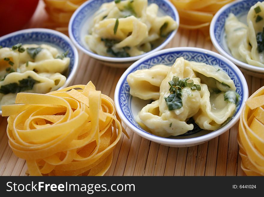 A meal of fresh pasta with cheese and spinach