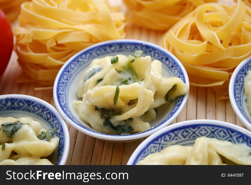 Some italian noodles with fresh spinach and cheese-sauce. Some italian noodles with fresh spinach and cheese-sauce
