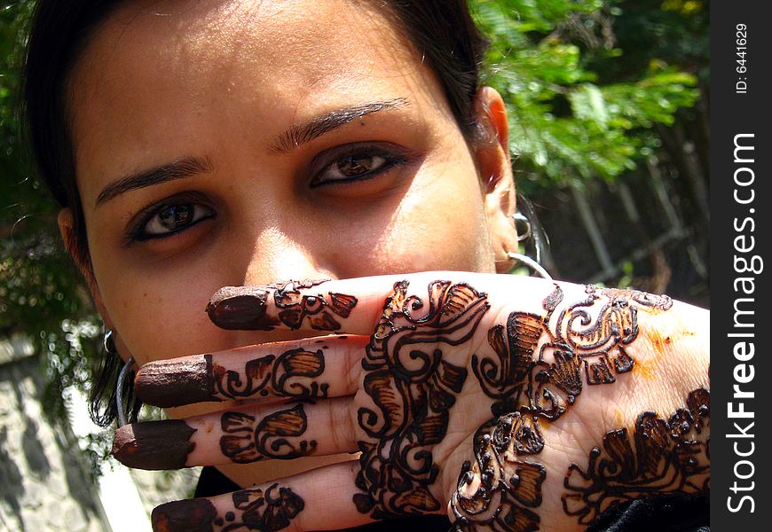 A girl with designed mehendi on her hand. A girl with designed mehendi on her hand