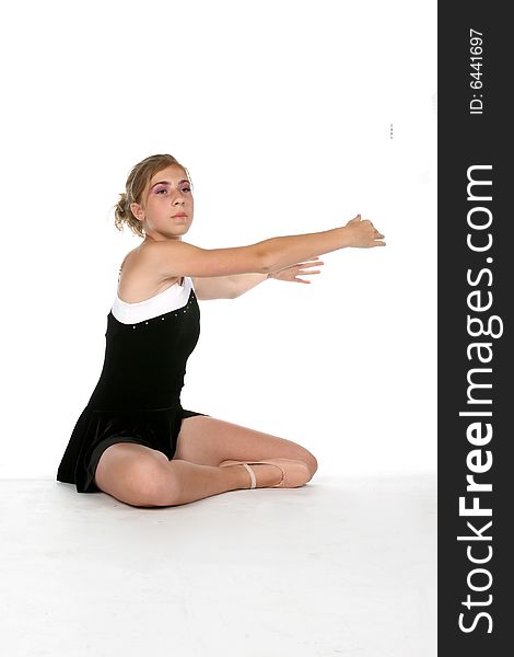 Young ballerina with arms extended; high key studio portrait. Young ballerina with arms extended; high key studio portrait