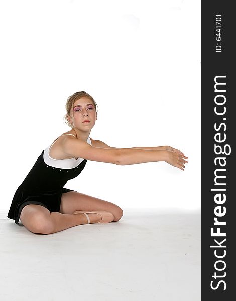 Pretty young girl doing stretching exercises on a high key background. Pretty young girl doing stretching exercises on a high key background