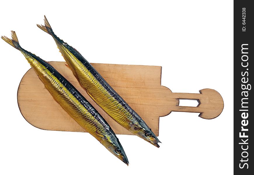 Two smoked fishes (Scombresox Saurus) on wooden board