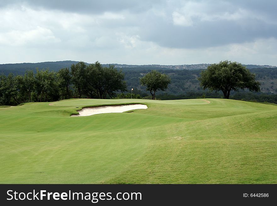 A view of the green on a scenic hill country golf course. A view of the green on a scenic hill country golf course