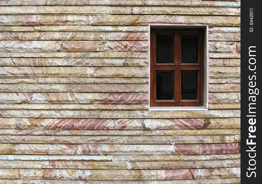 Wooden window on the house stone  wall