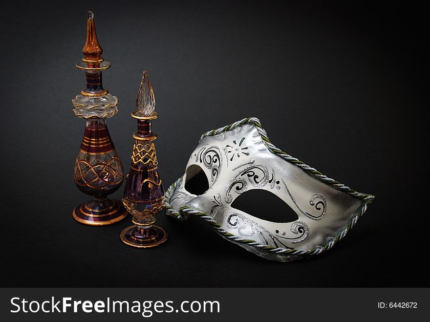 Two Venetian Glass jugs and a Venetian mask on black background. Two Venetian Glass jugs and a Venetian mask on black background