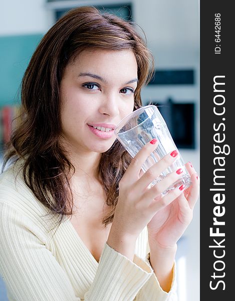 An attractive young woman at home in her kitchen. An attractive young woman at home in her kitchen