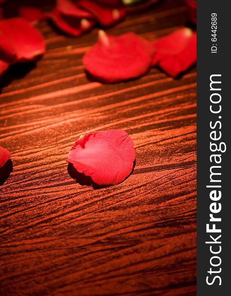 Red rose petals spread on the table for special occasion