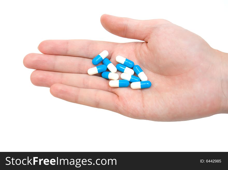 Pills on palm on white background. Pills on palm on white background