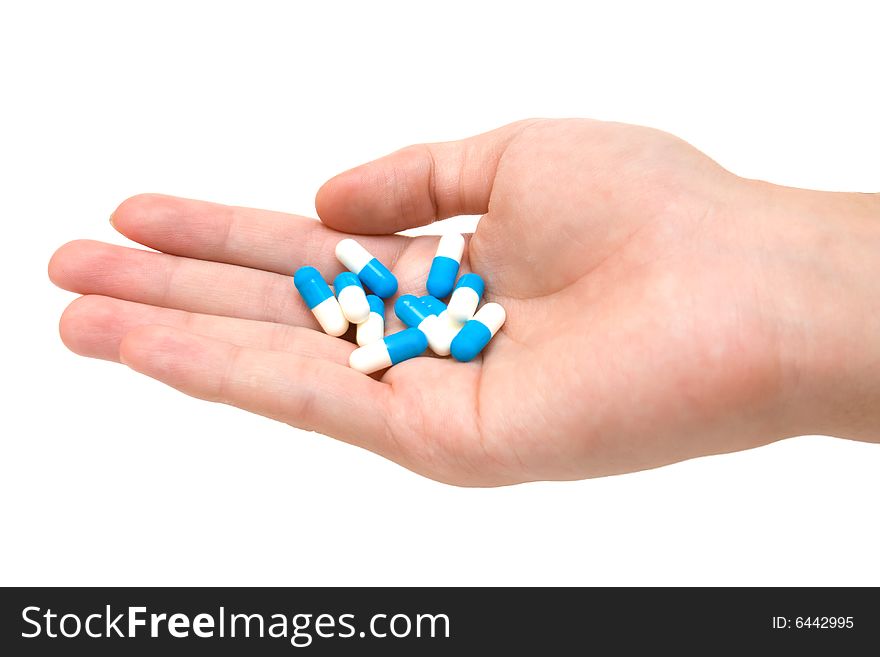 Pills on palm on white background