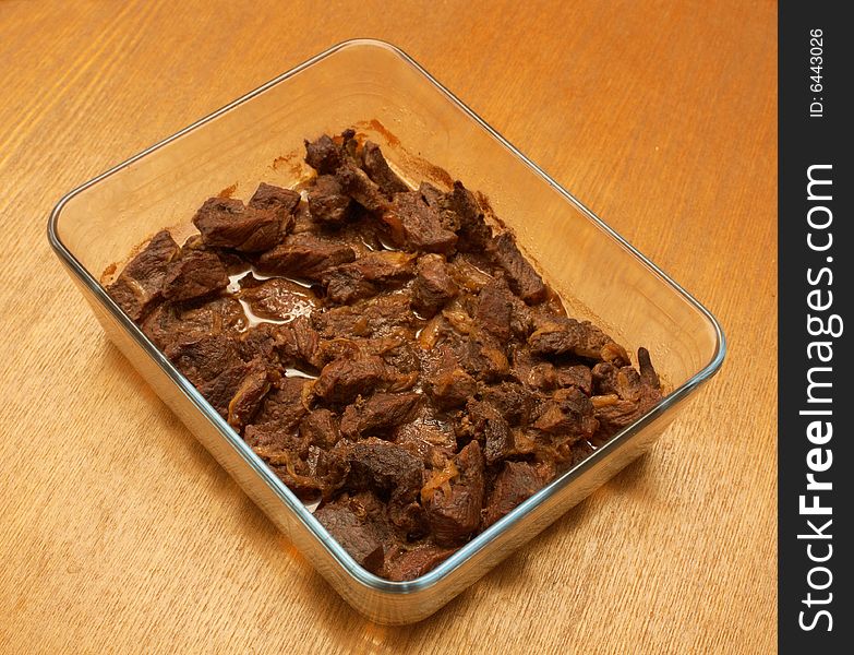 Fried meat in a glass container