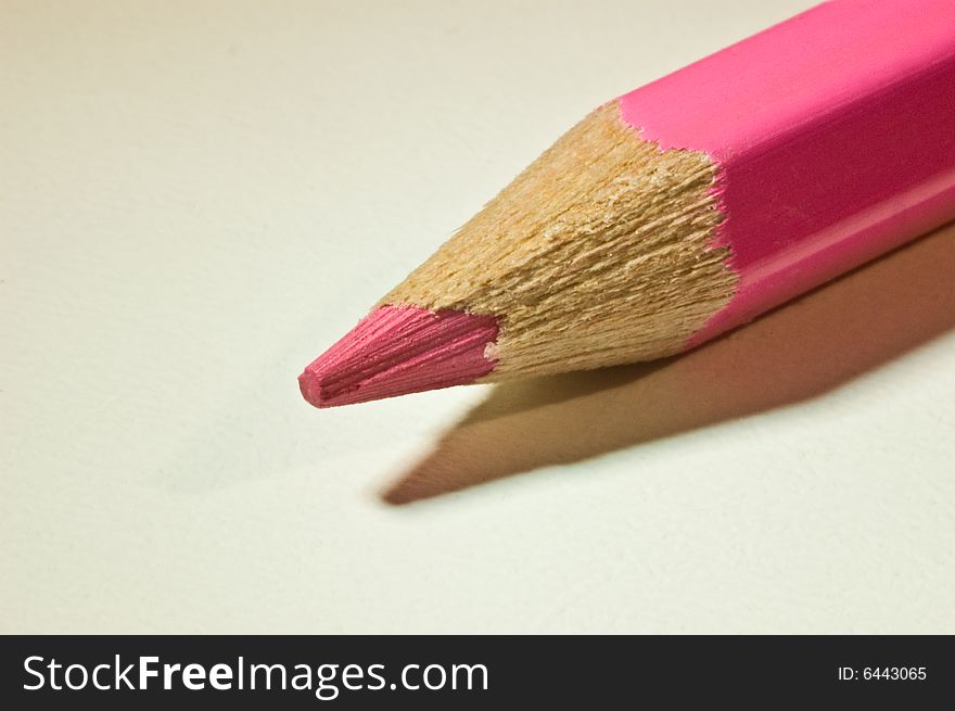 A violet pencil lying diagonal on a table. A violet pencil lying diagonal on a table.