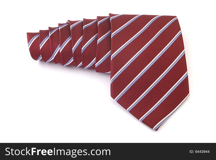 Red striped business tie rolled up over white background. Red striped business tie rolled up over white background