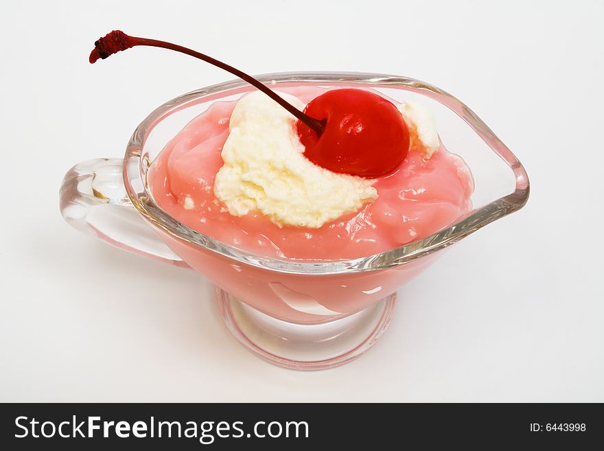 Sweet dessert with a cherry on a white background