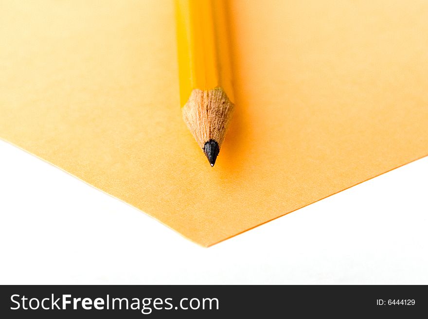 A photo of yellow pencil and yellow sheet of paper