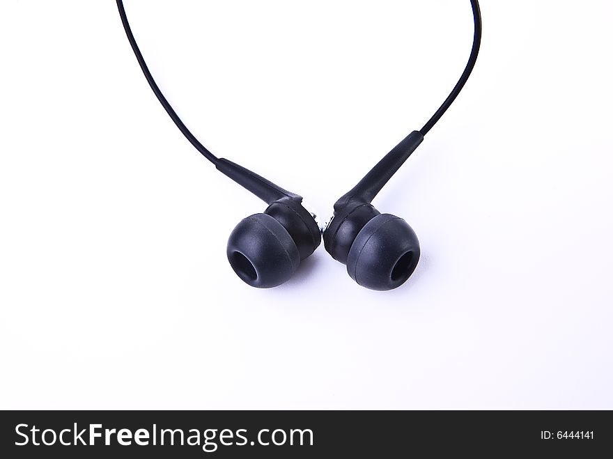 Black earphones on white background isolated