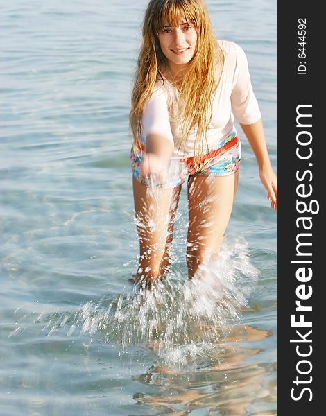 Beautiful girl playing in water drops. Beautiful girl playing in water drops