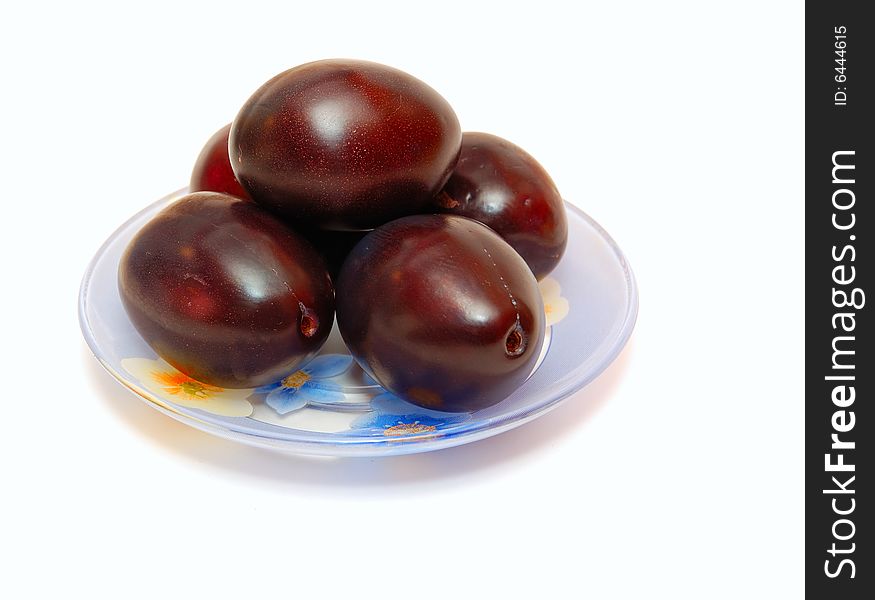 The ripe plums lying on a plate. The ripe plums lying on a plate