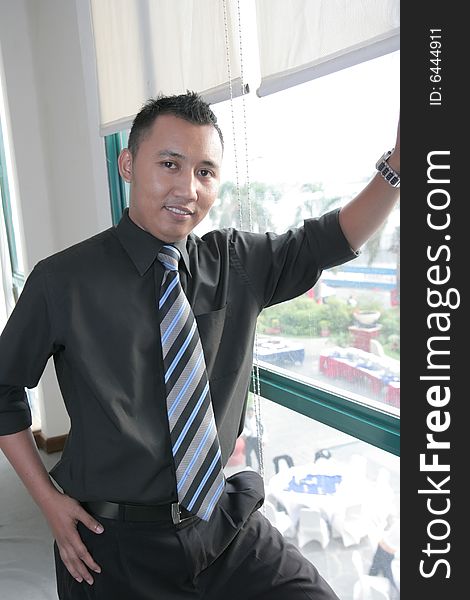 Business man at second floor office window