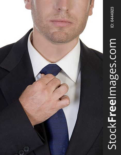 Close up of businessman fixing his tie on an isolated white background