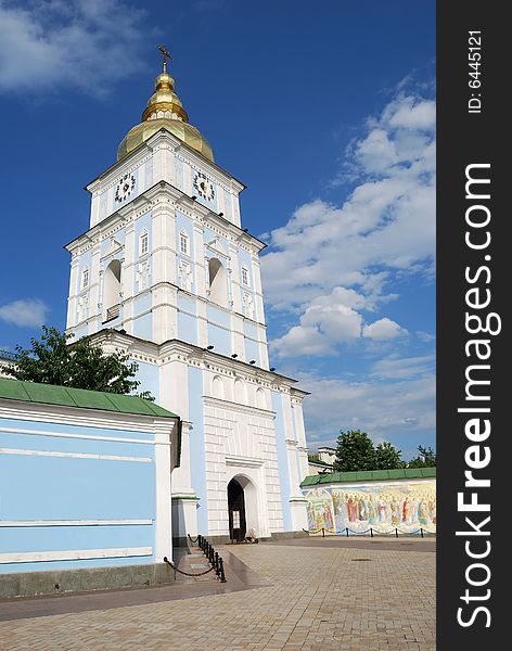 Bell tower above entrance in orthodox cathedral of Saint Michael, golden domes against blue sky. Bell tower above entrance in orthodox cathedral of Saint Michael, golden domes against blue sky