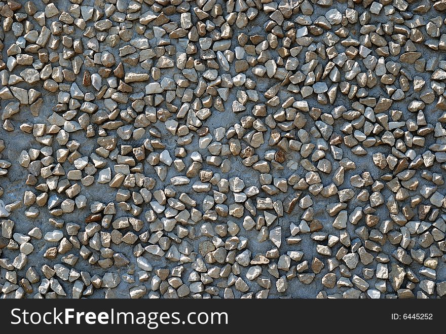 Cement grey background with small road-metal in sunlight. Cement grey background with small road-metal in sunlight