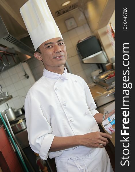 Chef at kitchen restaurant standing and smiling