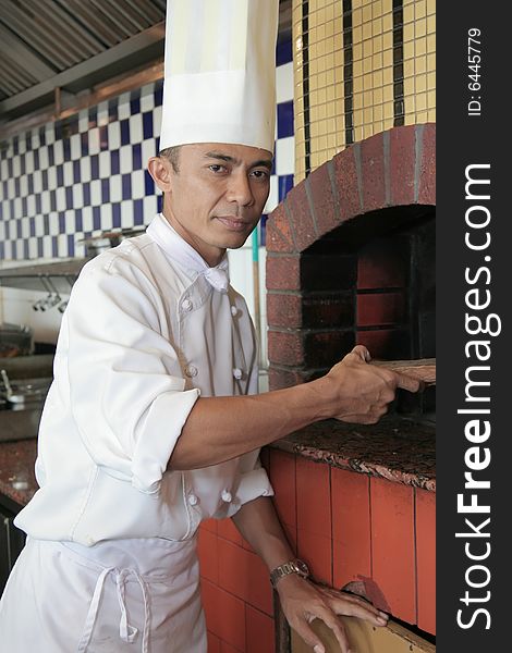 Chef standing at front of pizza restaurant. Chef standing at front of pizza restaurant